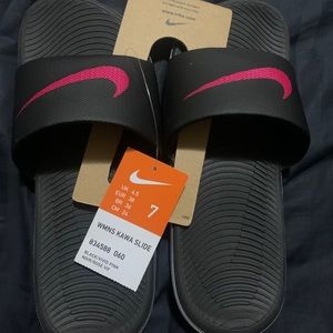 Pink and black Nike slides